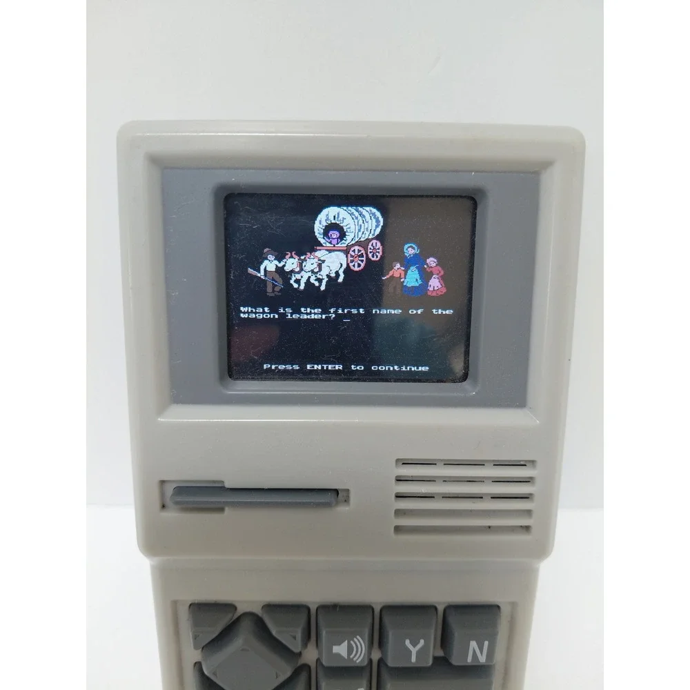 The Oregon Trail‎ Handheld Electronic Game Basic Fun 09597 Retro Travel Toy Grey